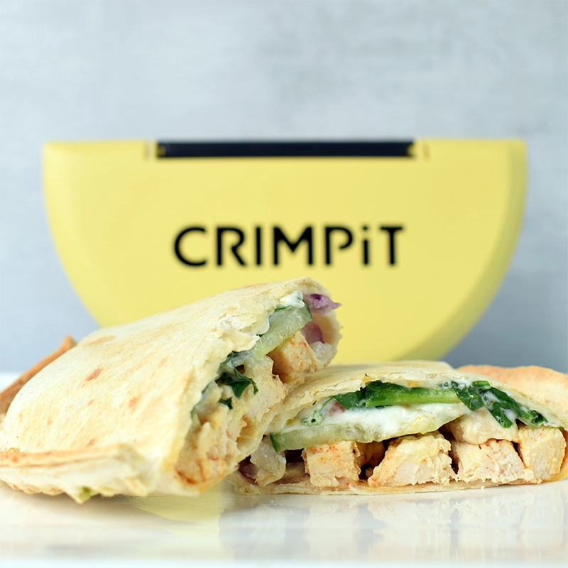 Cooked tortilla with chicken filling. A CRIMPiT Tortilla Sealer behind the tortilla. 
