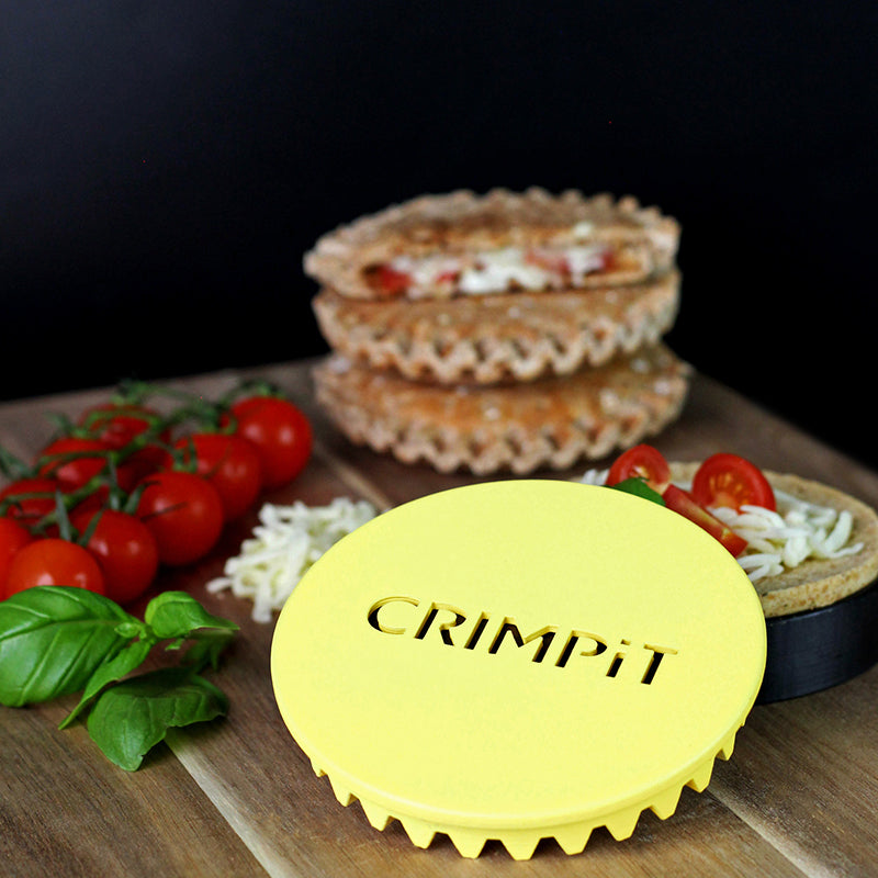 An image of the CRIMPiT Circle on a table with toasted snacks and ingredients. 